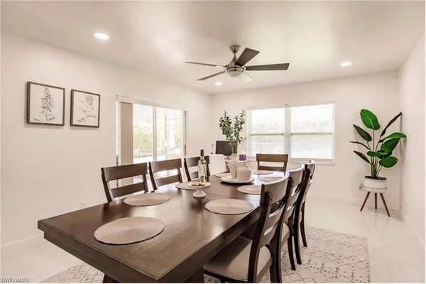 a view of a dining room with furniture and a potted plant