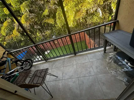 a view of a balcony with wooden floor