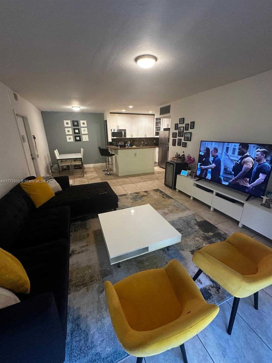 7951 Southwest 104th Street, Unit 210D Miami, FL 33156 - Photo 6 of 15 a living room with furniture and a wooden floor