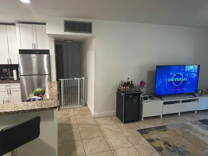 a kitchen with stainless steel appliances granite countertop a refrigerator and a stove