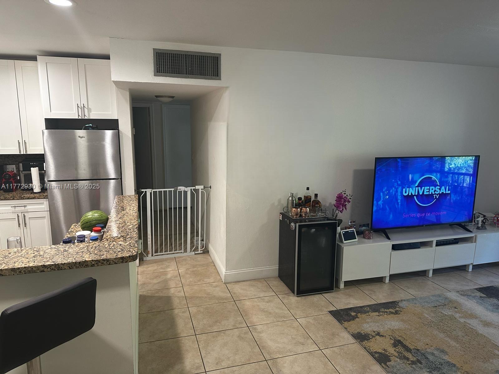 7951 Southwest 104th Street, Unit 210D Miami, FL 33156 - Photo 8 of 15 a kitchen with stainless steel appliances granite countertop a refrigerator and a stove