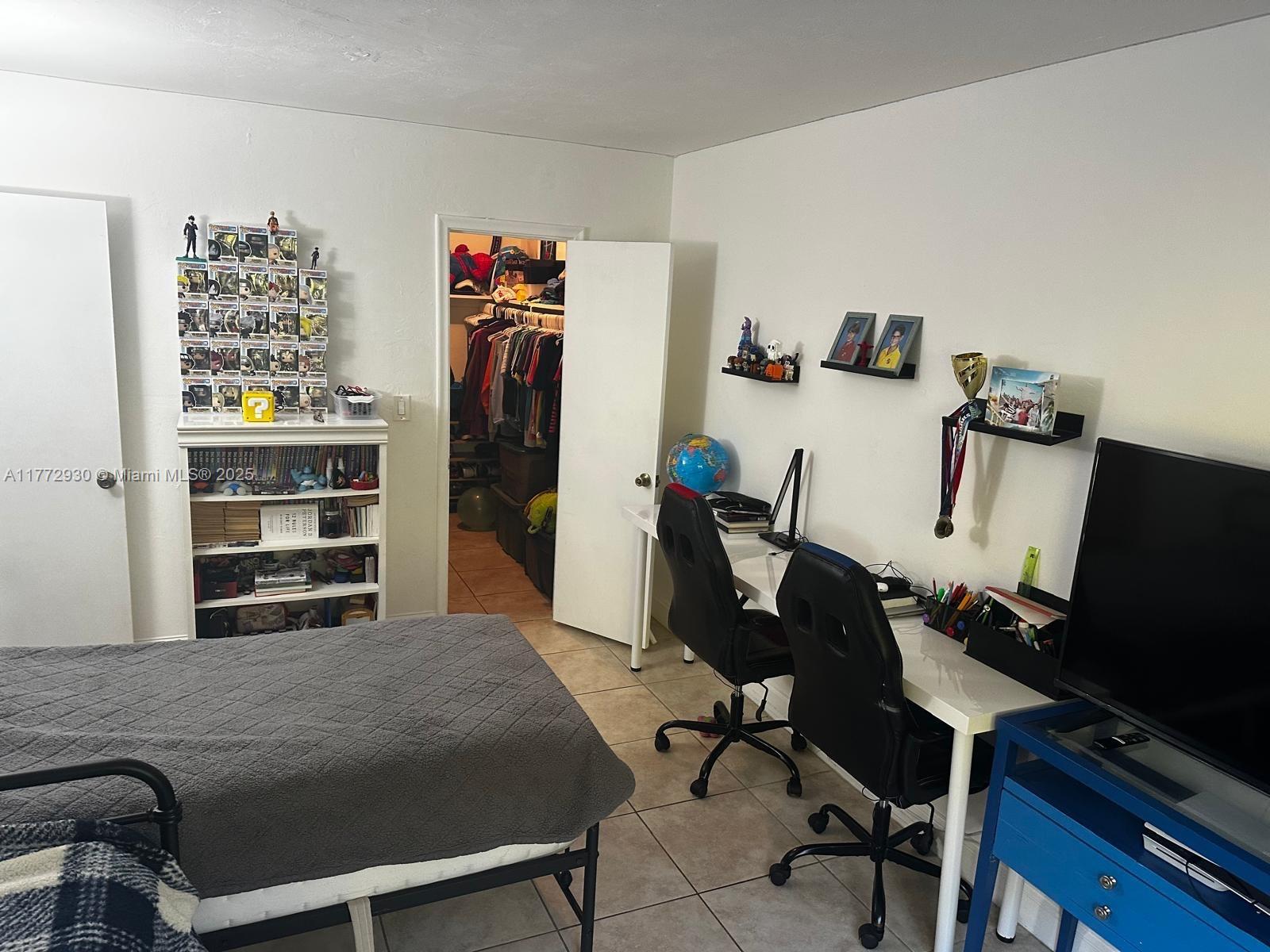 7951 Southwest 104th Street, Unit 210D Miami, FL 33156 - Photo 10 of 15 a view of a workspace with furniture and bedroom