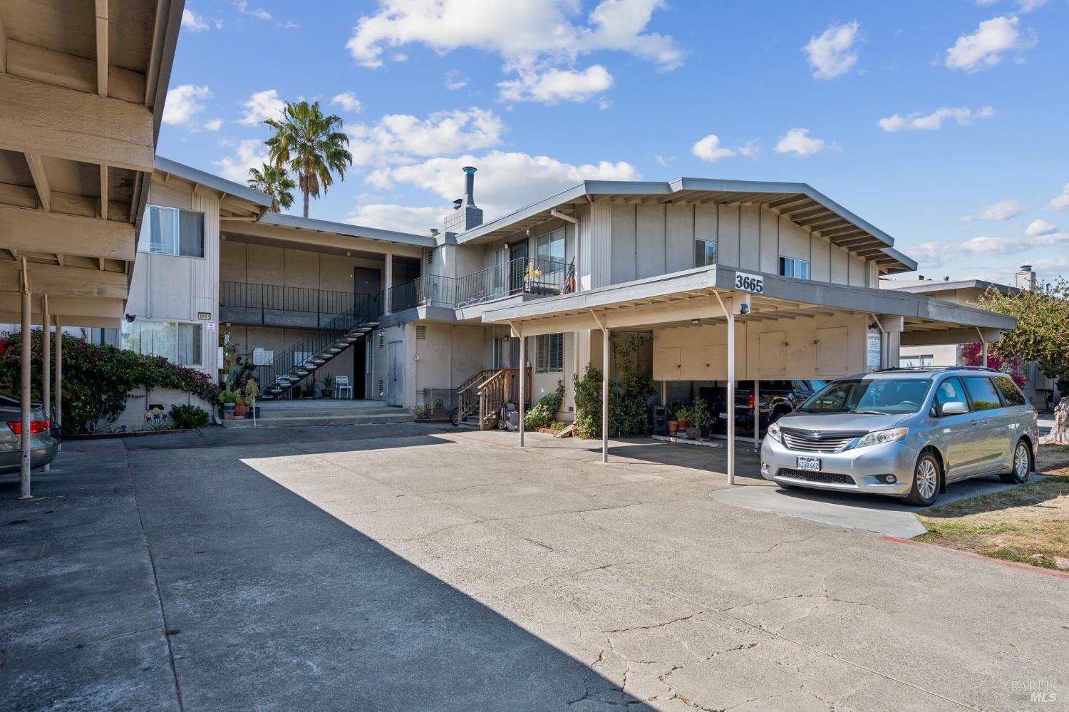 a car parked in front of white house