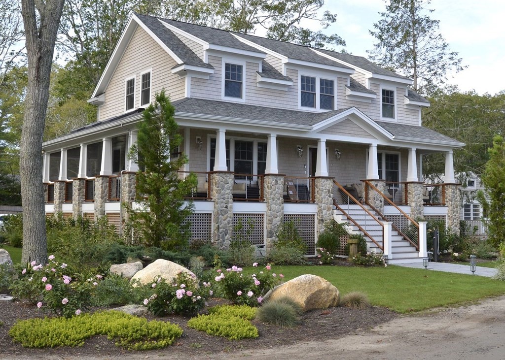 a front view of a house with a yard and fountain