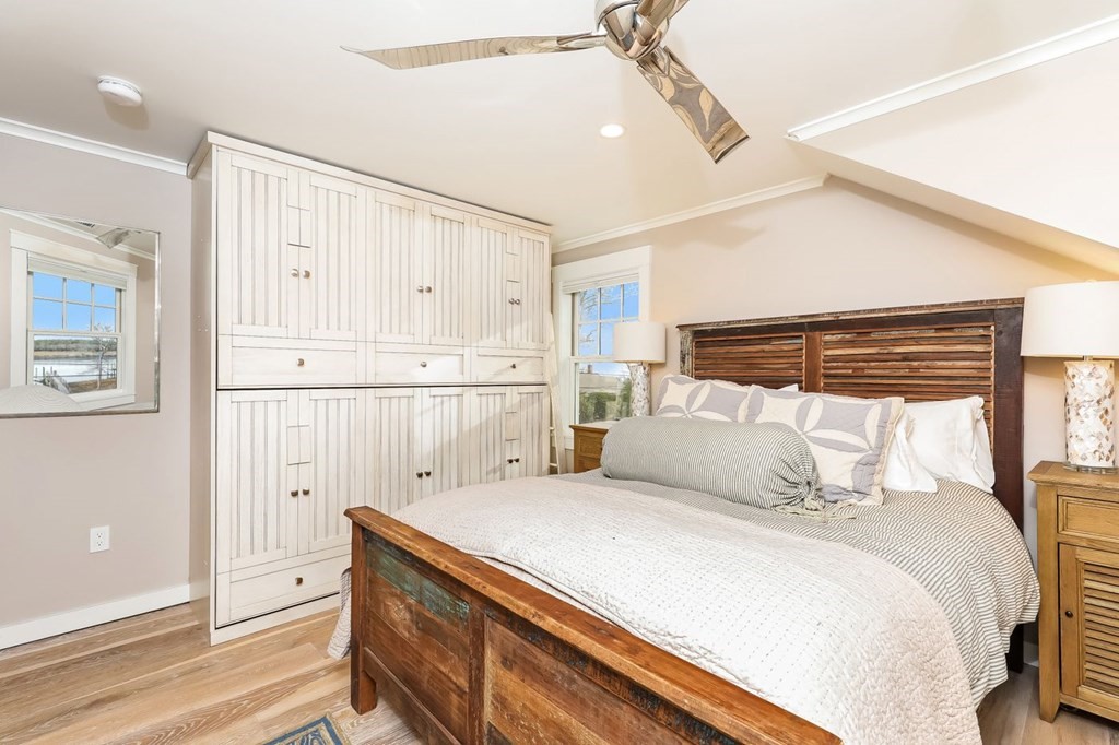 40 Dexter Road Marion, MA 02738 - Photo 17 of 27 a bedroom with a large bed and a chandelier fan