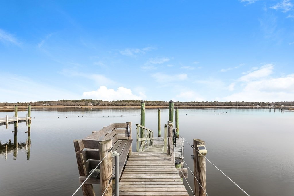 40 Dexter Road Marion, MA 02738 - Photo 4 of 27 a view of a lake with a table and chairs