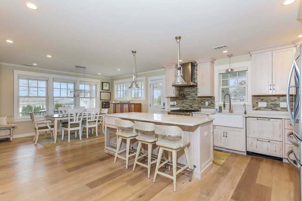 40 Dexter Road Marion, MA 02738 - Photo 5 of 27 a kitchen with white cabinets and wooden floor
