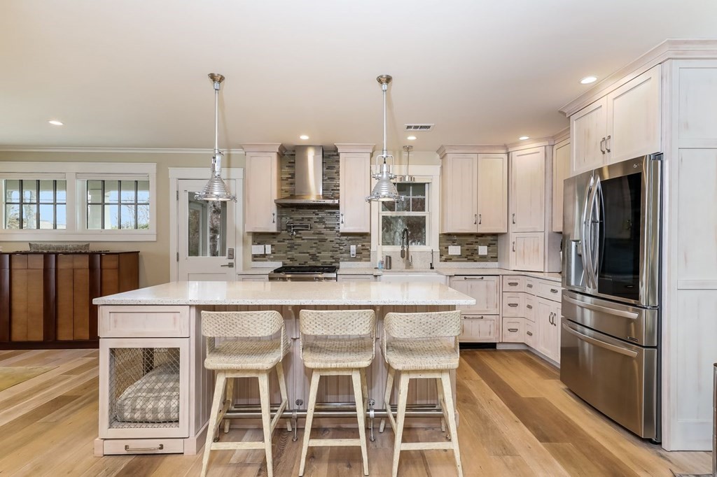 40 Dexter Road Marion, MA 02738 - Photo 7 of 27 a kitchen with stainless steel appliances kitchen island granite countertop a stove a table and chairs