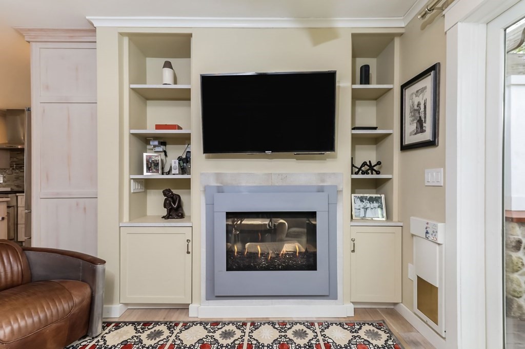 40 Dexter Road Marion, MA 02738 - Photo 10 of 27 a living room with a fireplace and a flat screen tv