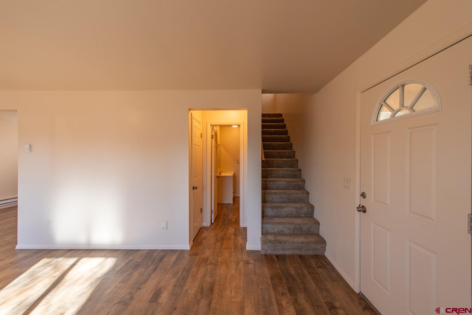 525 Elizabeth Street Delta, CO 81416 - Photo 11 of 30 a view of a hallway with wooden floor and staircase