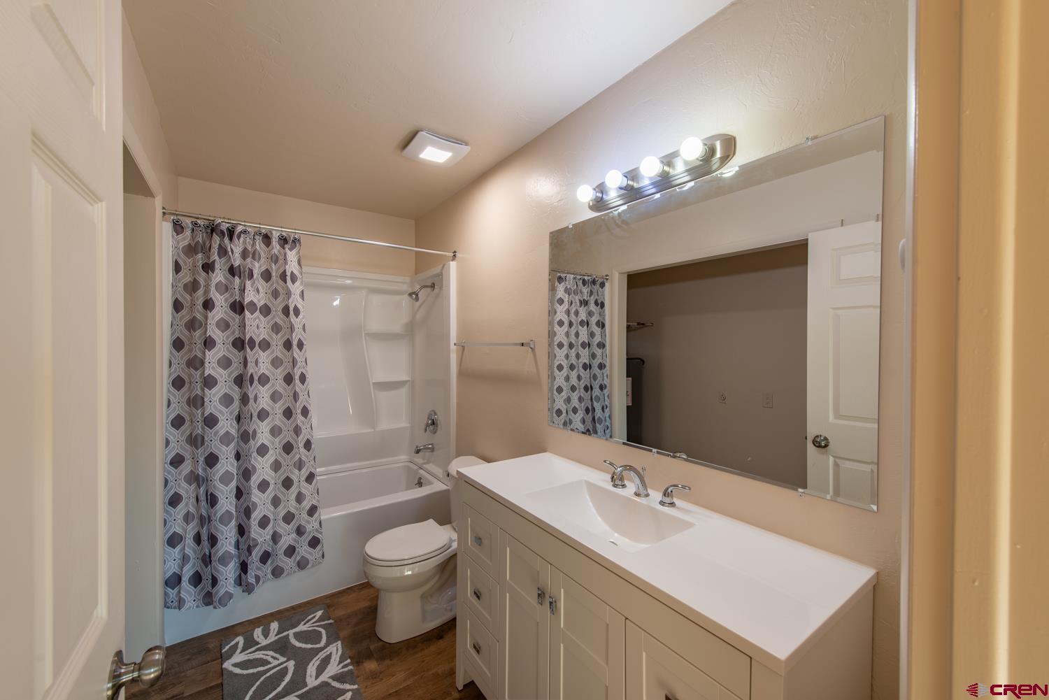525 Elizabeth Street Delta, CO 81416 - Photo 22 of 30 a bathroom with a sink toilet a shower and a mirror