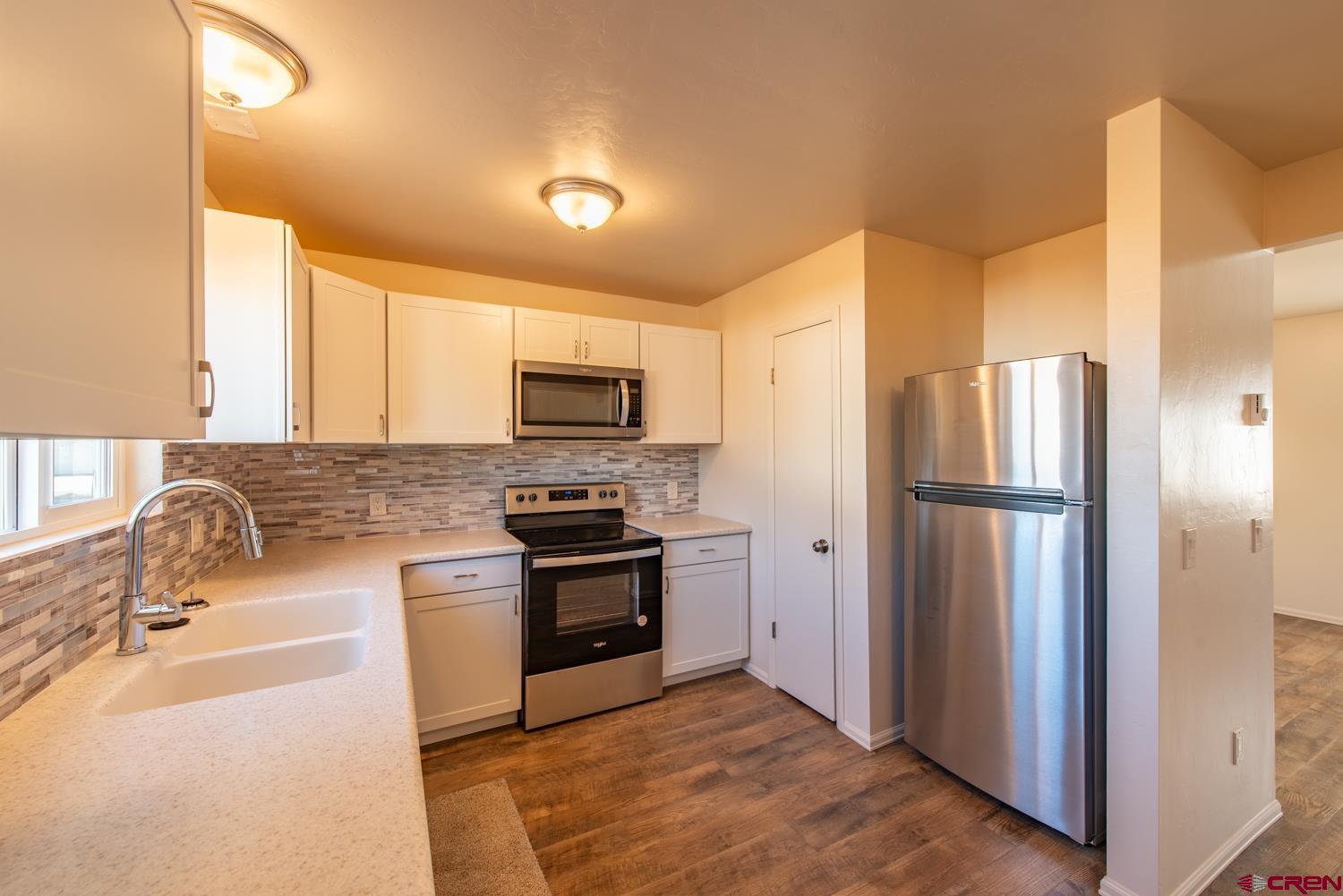 525 Elizabeth Street Delta, CO 81416 - Photo 4 of 30 a kitchen with stainless steel appliances granite countertop a refrigerator and a sink