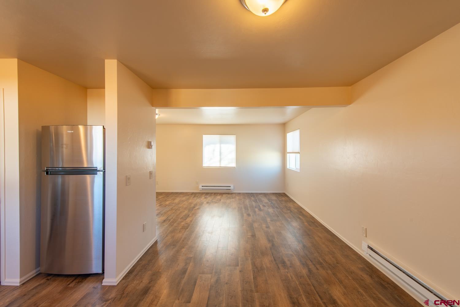 525 Elizabeth Street Delta, CO 81416 - Photo 5 of 30 a view of empty room with wooden floor and fan