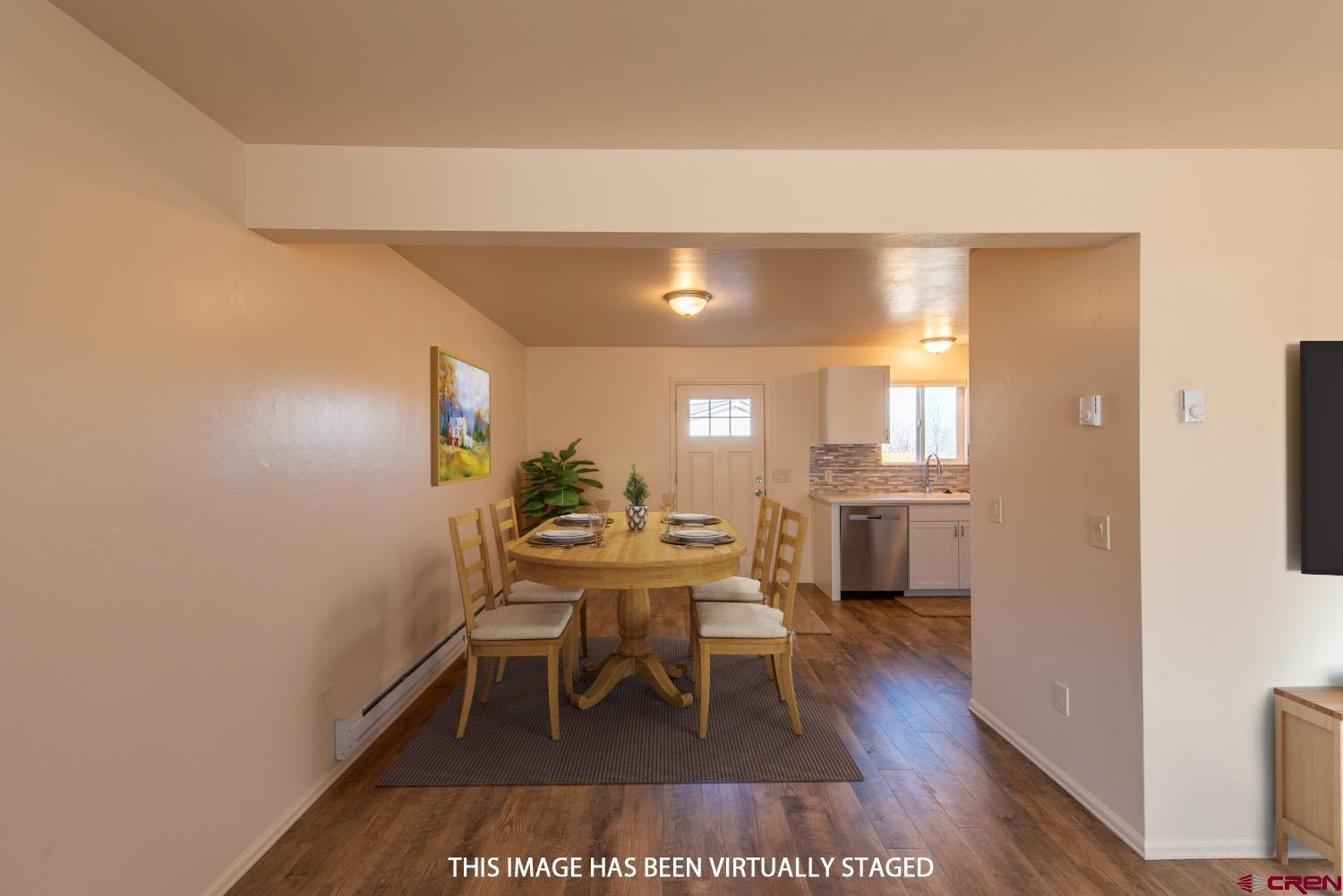 525 Elizabeth Street Delta, CO 81416 - Photo 9 of 30 a dining room with furniture and wooden floor