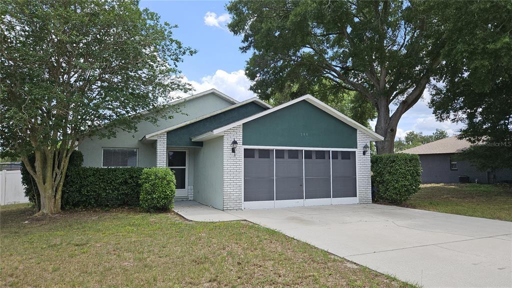 108 Brittany Road Mascotte, FL 34753 - Photo 1 of 17 front view of a house with a yard and an trees