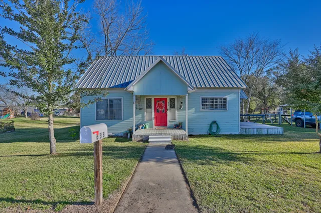 a front view of a house with a yard garden