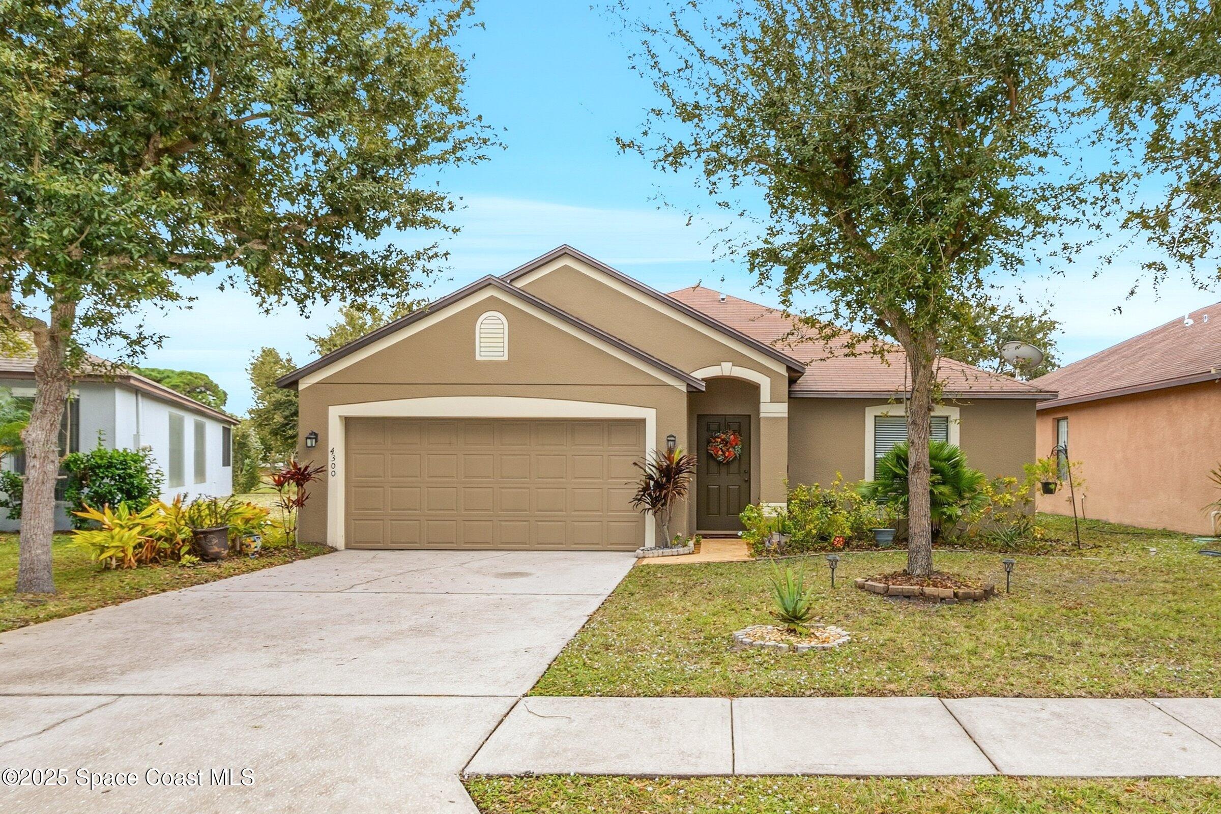 4300 Millicent Circle Melbourne, FL 32901 - Photo 1 of 29 a front view of a house with garden