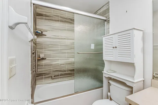 a bathroom with a shower and a toilet