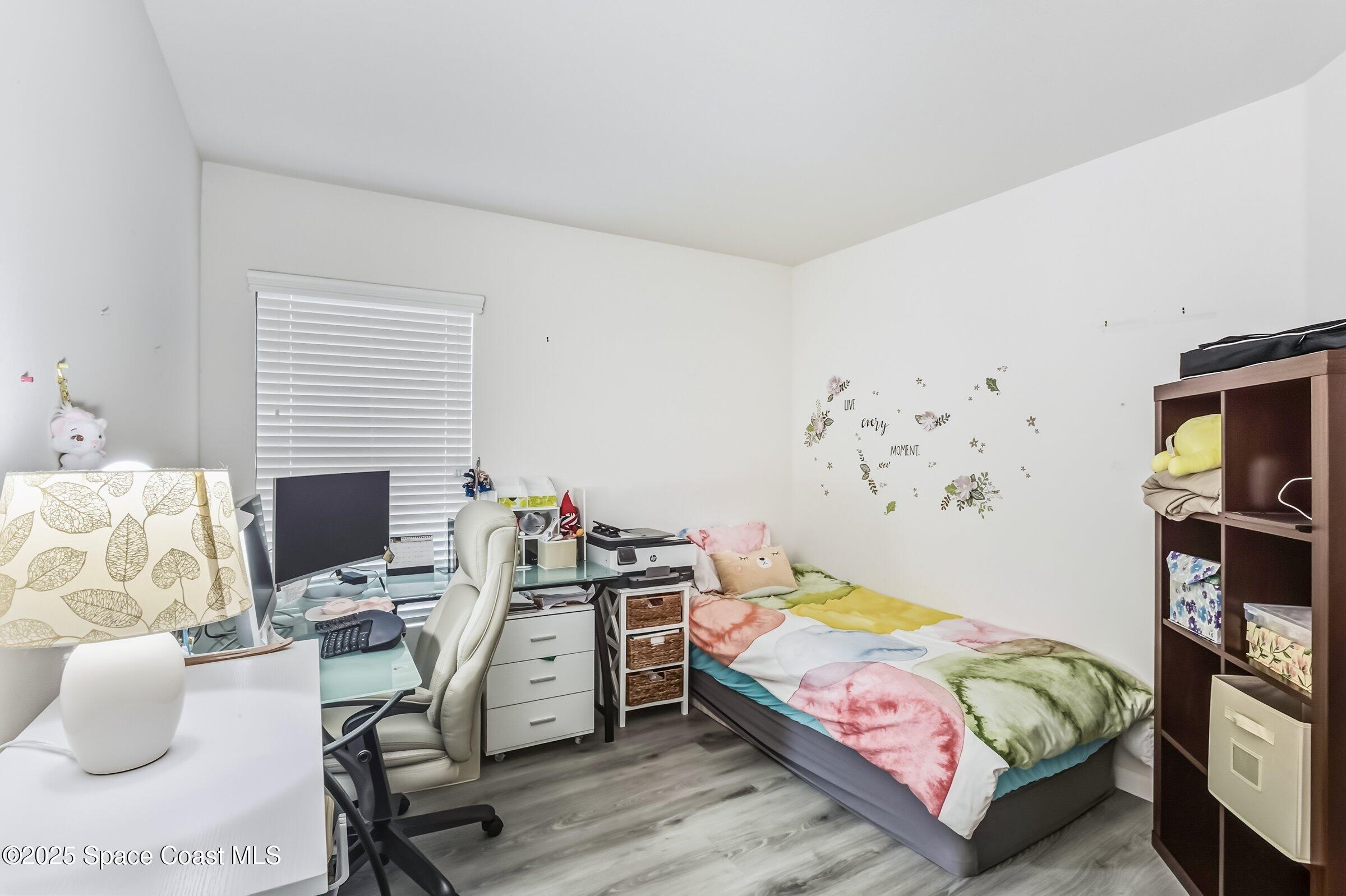 4300 Millicent Circle Melbourne, FL 32901 - Photo 12 of 29 a bedroom with a bed and a flat screen tv