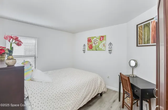 a bedroom with a bed and a table in it