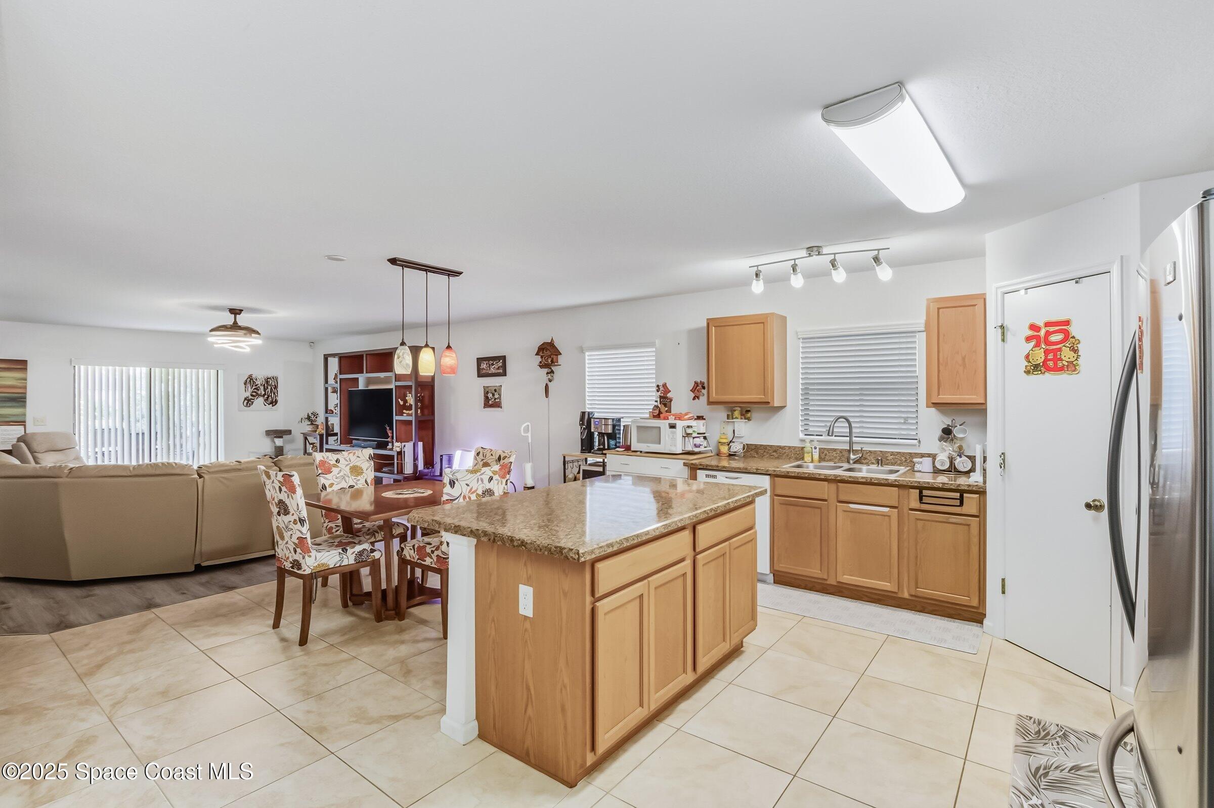 4300 Millicent Circle Melbourne, FL 32901 - Photo 14 of 29 a kitchen with a sink and chairs