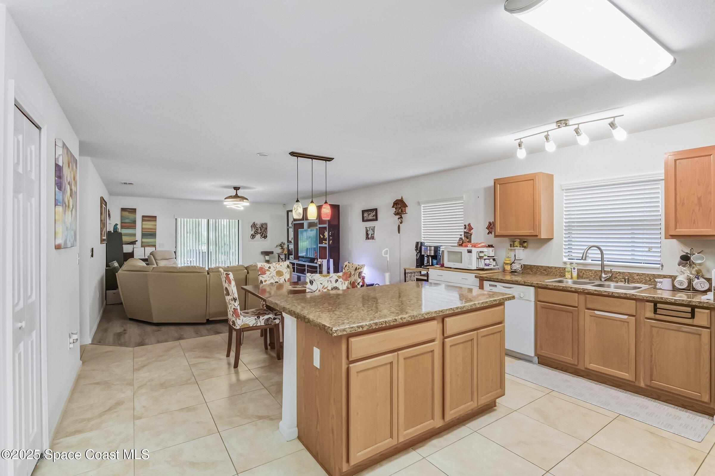 4300 Millicent Circle Melbourne, FL 32901 - Photo 15 of 29 a view of kitchen with sink island and living room