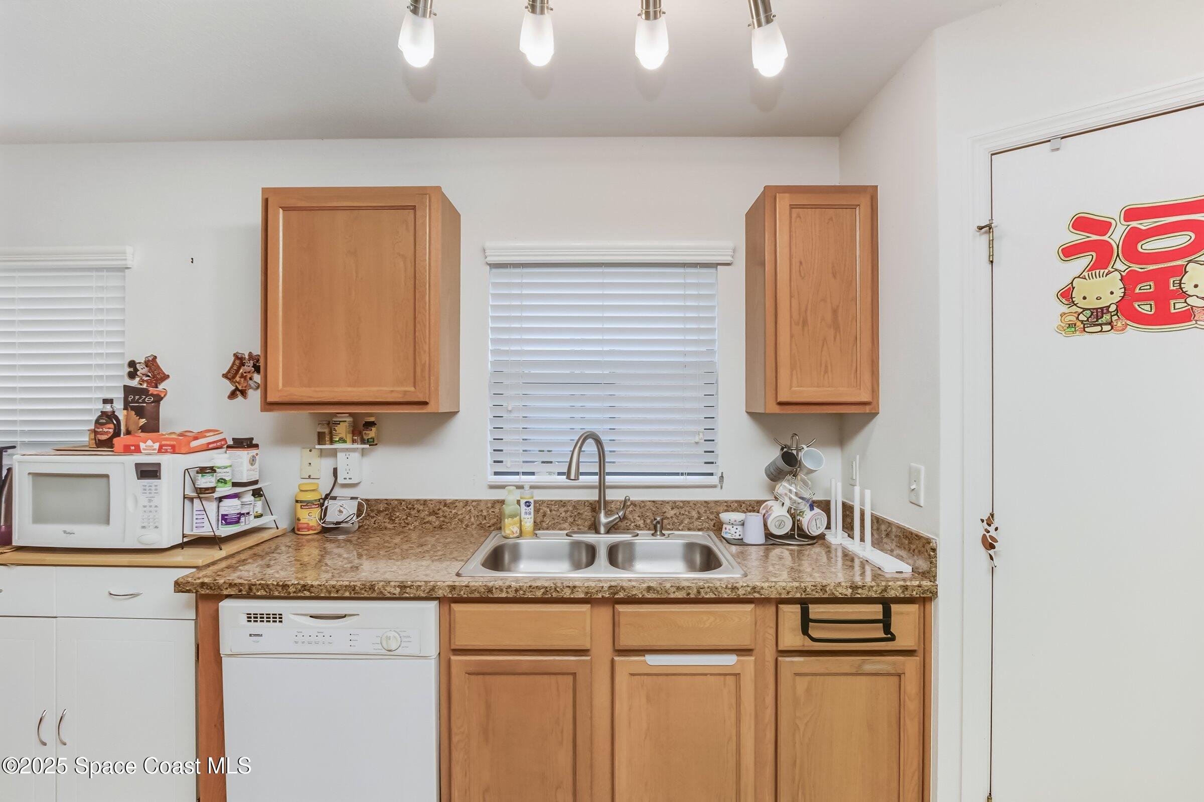 4300 Millicent Circle Melbourne, FL 32901 - Photo 16 of 29 a kitchen with a sink and cabinets