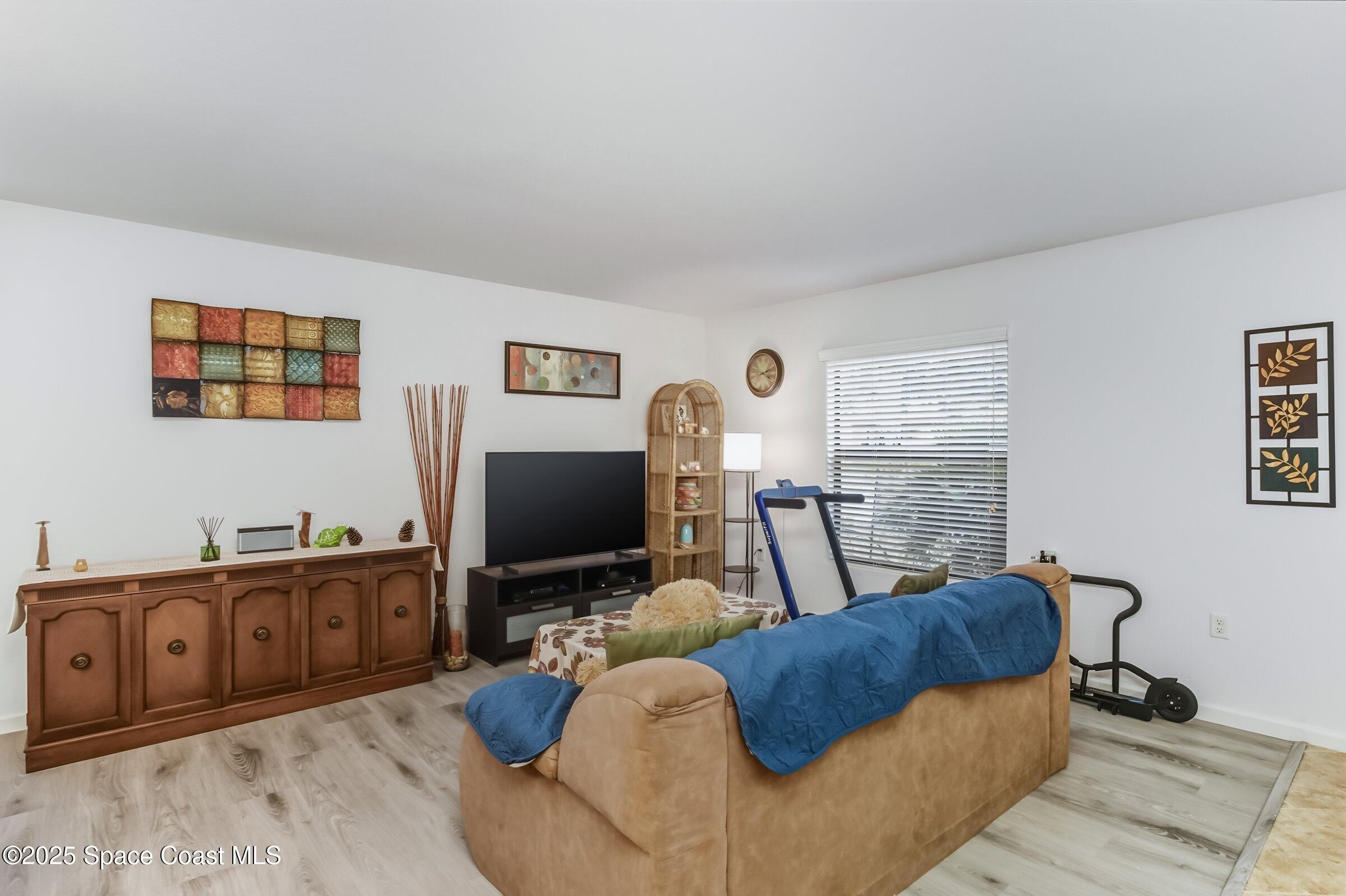 4300 Millicent Circle Melbourne, FL 32901 - Photo 20 of 29 a living room with furniture and a flat screen tv
