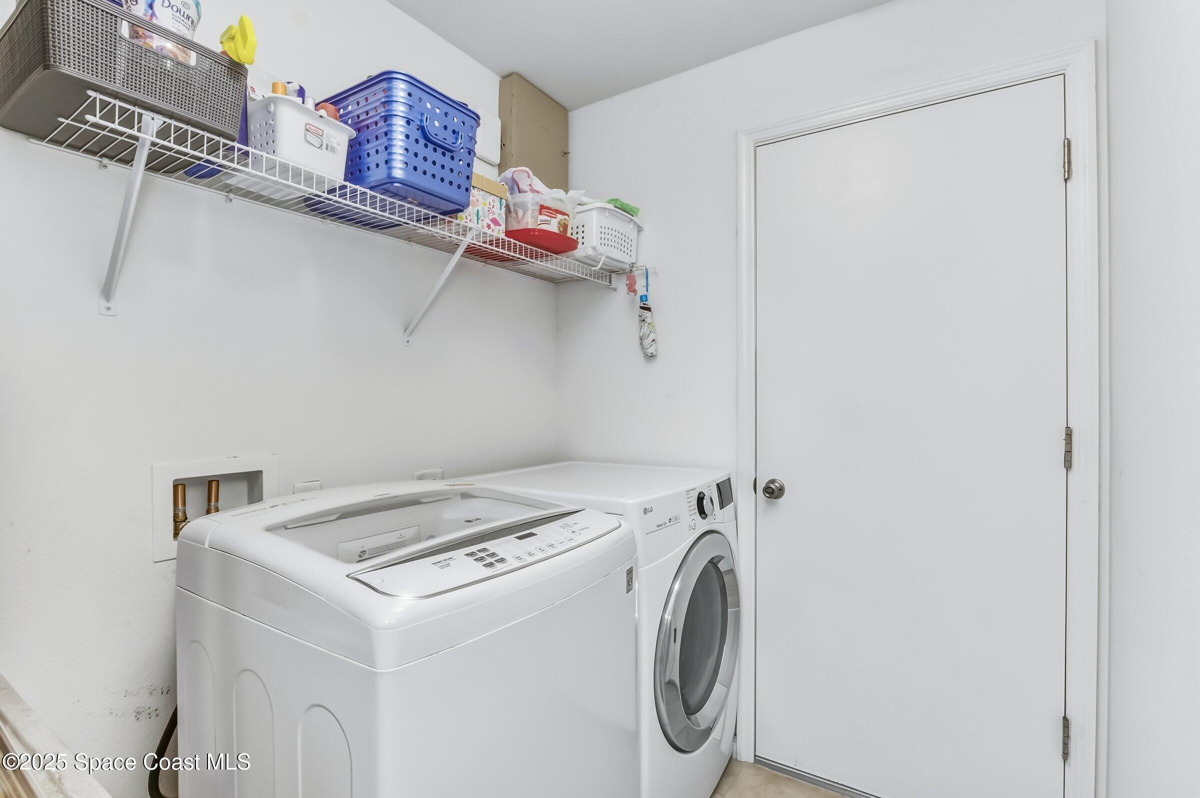 4300 Millicent Circle Melbourne, FL 32901 - Photo 21 of 29 a utility room with dryer and washer