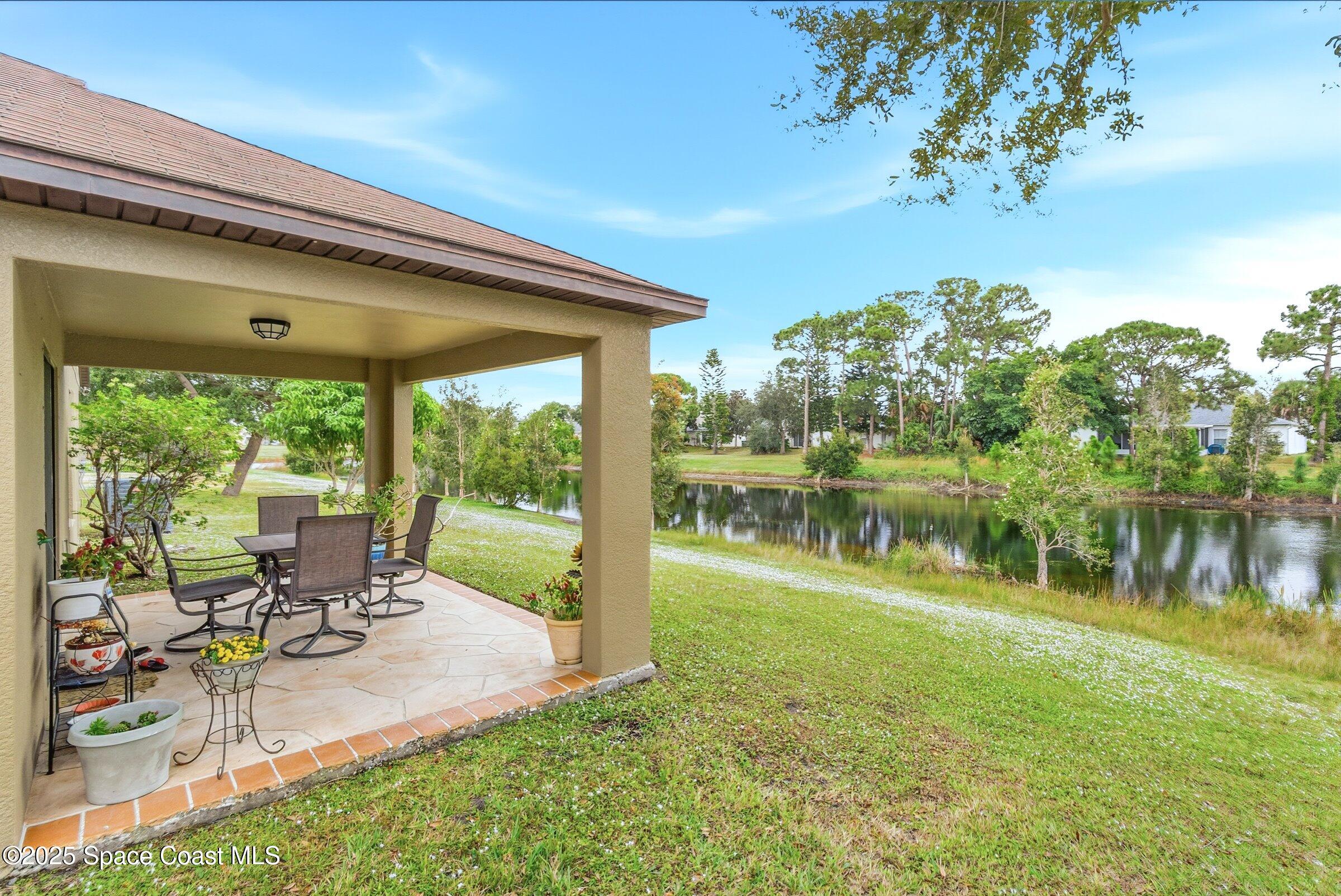 4300 Millicent Circle Melbourne, FL 32901 - Photo 23 of 29 a view of swimming pool with a table and chairs in patio