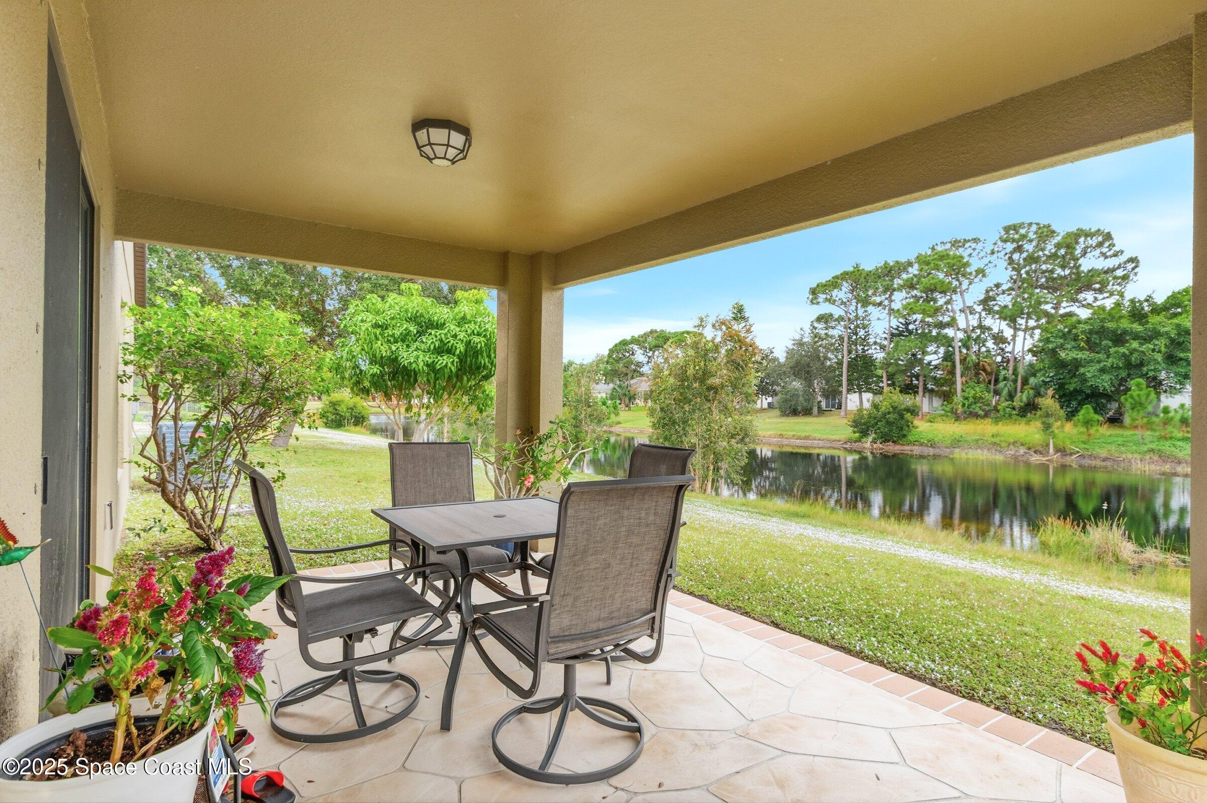 4300 Millicent Circle Melbourne, FL 32901 - Photo 24 of 29 a view of a chairs and table in patio next to a yard