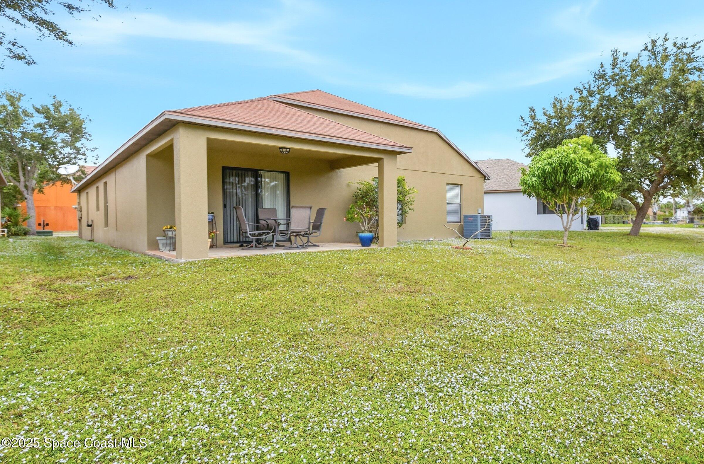 4300 Millicent Circle Melbourne, FL 32901 - Photo 27 of 29 a view of a house with a big yard and large trees