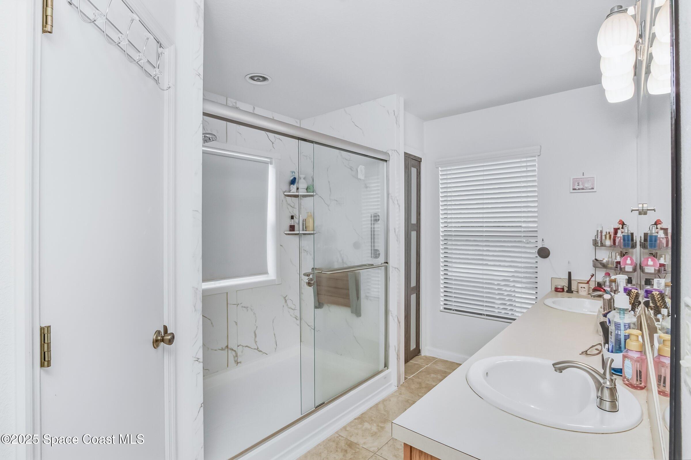 4300 Millicent Circle Melbourne, FL 32901 - Photo 5 of 29 a bathroom with a sink and a mirror