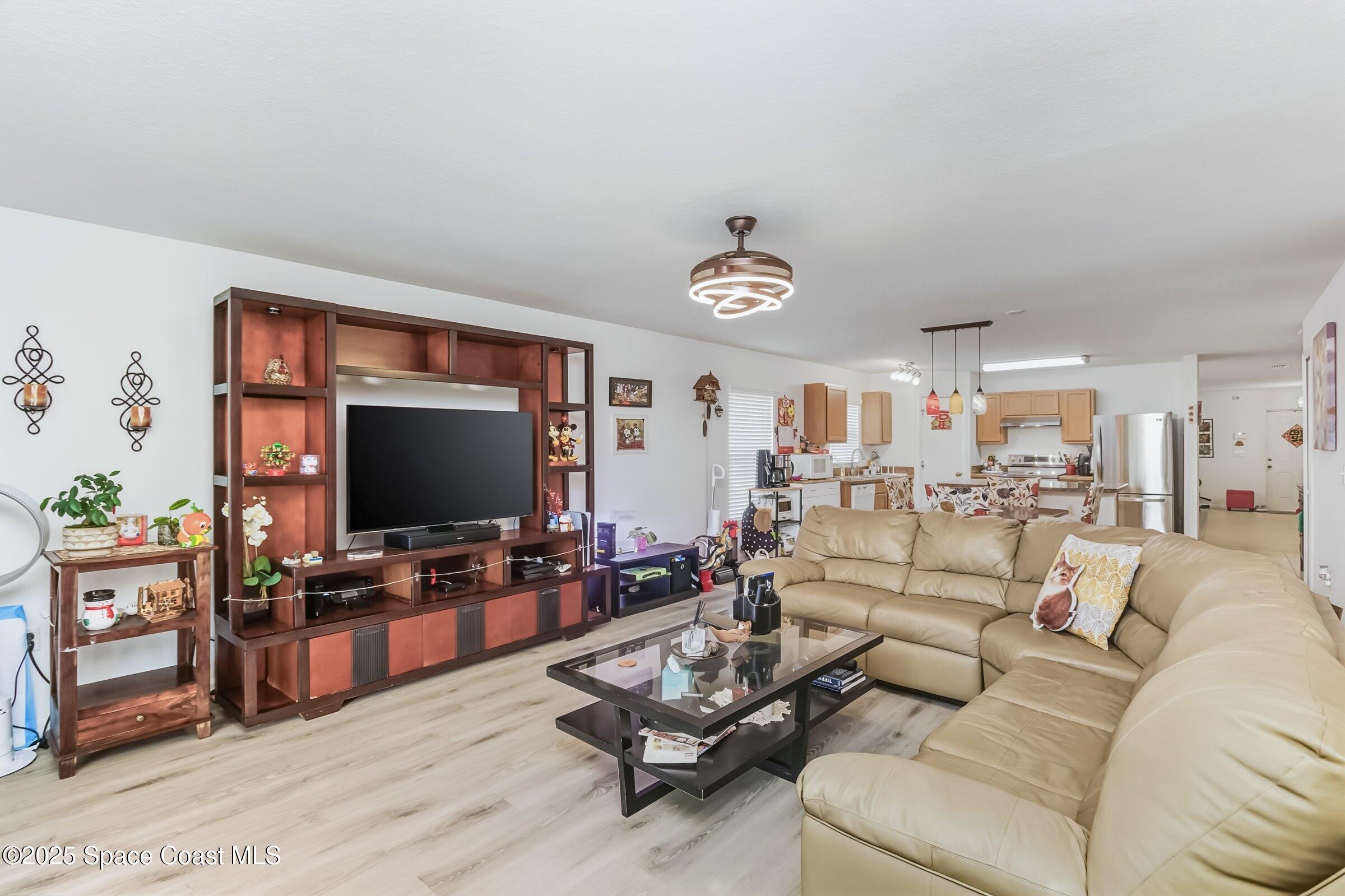 4300 Millicent Circle Melbourne, FL 32901 - Photo 7 of 29 a living room with furniture and a flat screen tv