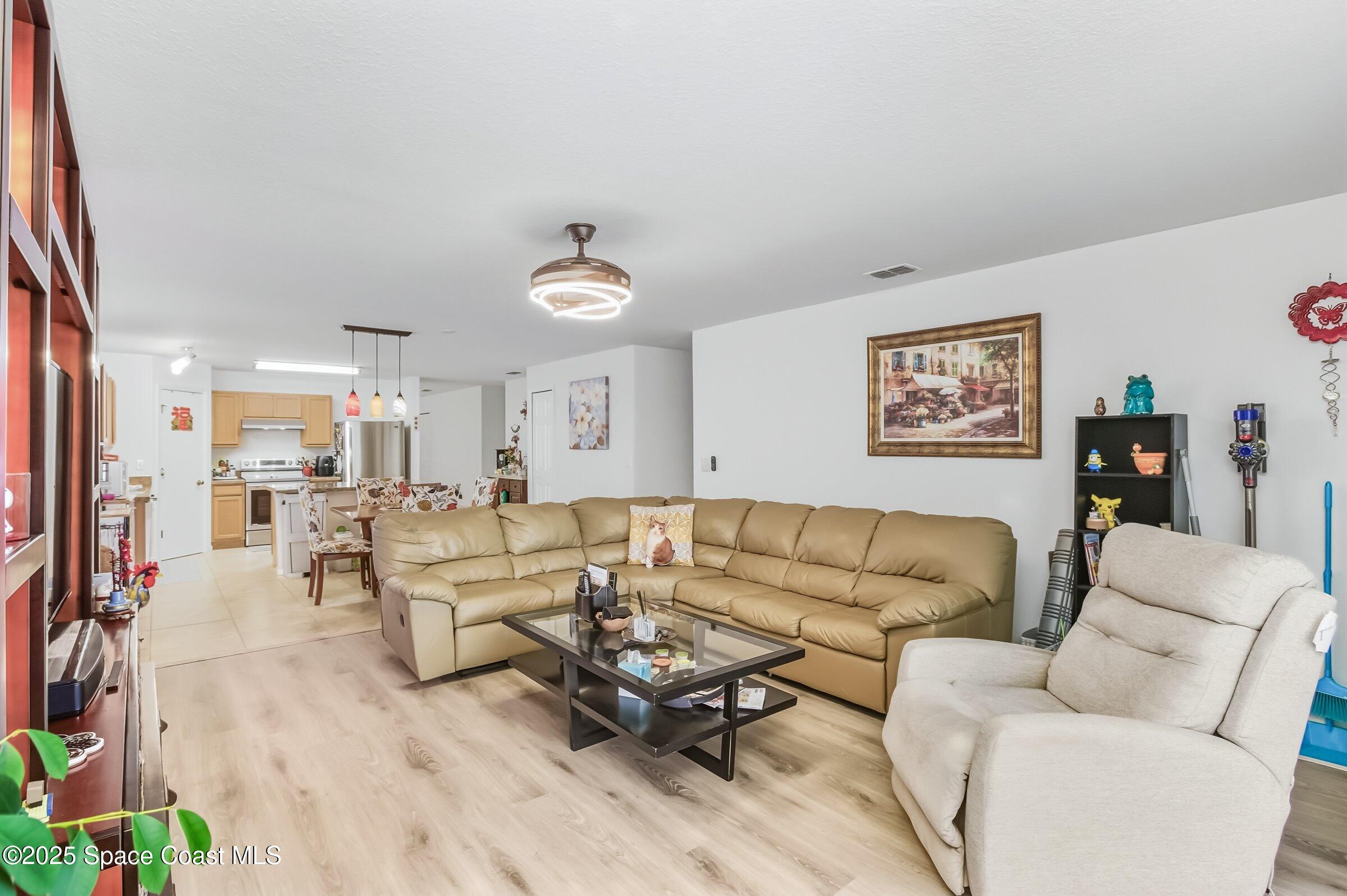 4300 Millicent Circle Melbourne, FL 32901 - Photo 8 of 29 a living room with furniture and a couch