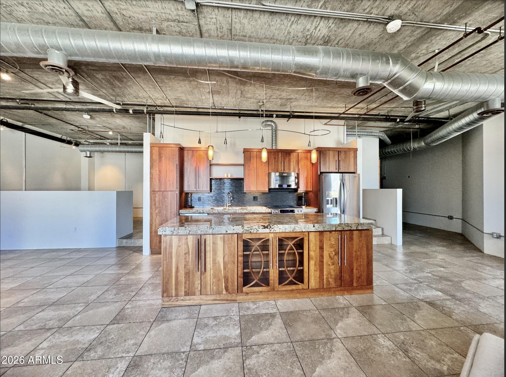 21 East 6th Street, Unit 306 Tempe, AZ 85281 - Photo 12 of 31 a large kitchen with stainless steel appliances and cabinets