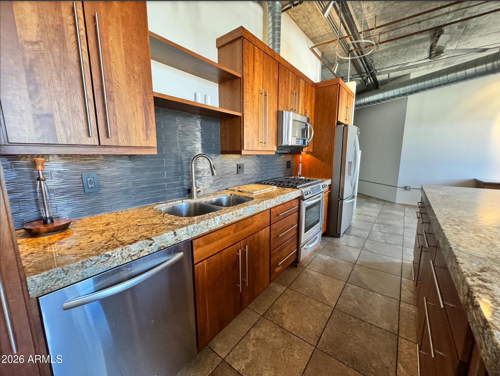 21 East 6th Street, Unit 306 Tempe, AZ 85281 - Photo 17 of 31 a kitchen with stainless steel appliances granite countertop a sink and cabinets