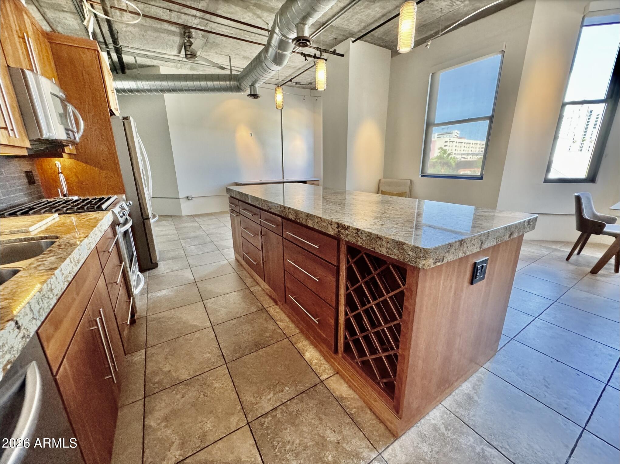 21 East 6th Street, Unit 306 Tempe, AZ 85281 - Photo 18 of 31 a kitchen with stainless steel appliances granite countertop a sink stove and cabinets