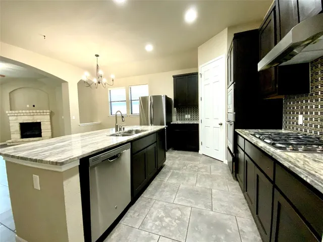 a large kitchen with a stove and a sink