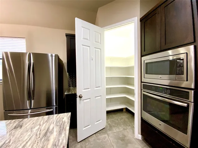 a kitchen with a refrigerator and microwave