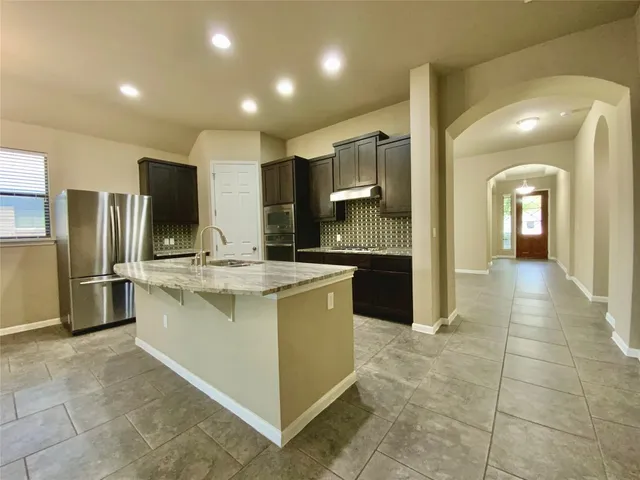 a large bathroom with a large mirror vanity and shower