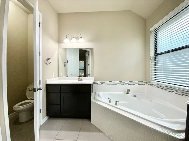 a bathroom with a bathtub and a sink