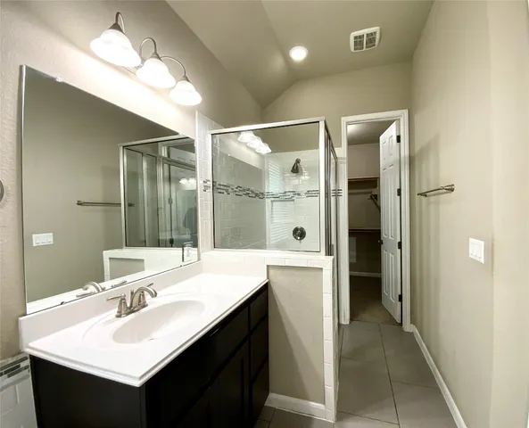 a bathroom with a sink double vanity and a mirror
