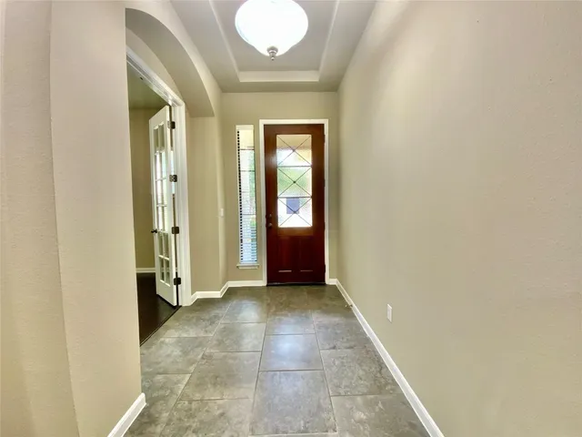 a view of a hallway with wooden shelves