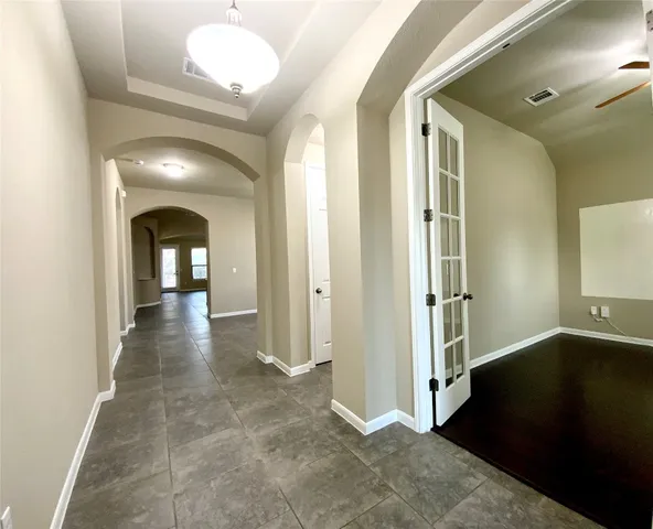 a view of a hallway with wooden floor and staircase