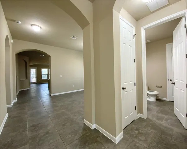 a view of a hallway with bathroom and a bathroom
