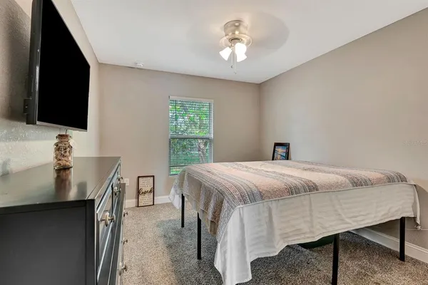 a bedroom with a bed and a flat screen tv