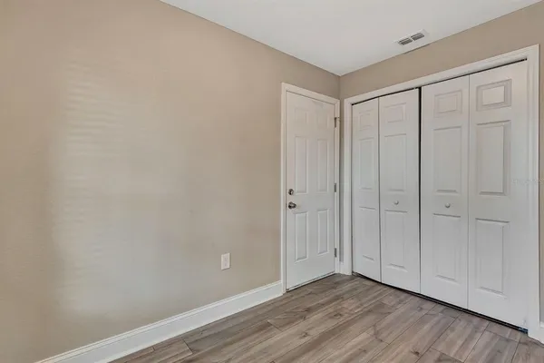 a view of an empty room and wooden floor