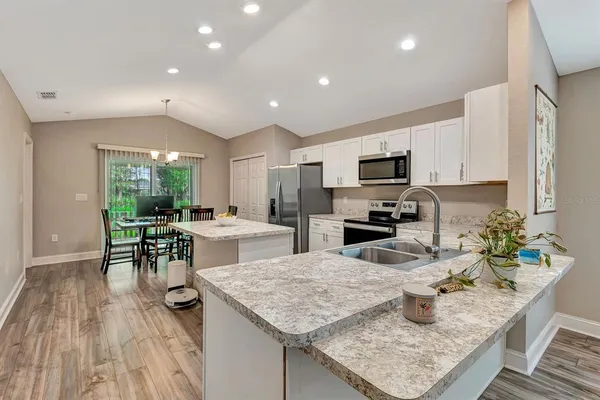 a kitchen with a stove a sink and a refrigerator