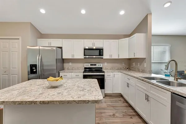 a kitchen with a sink a stove and refrigerator